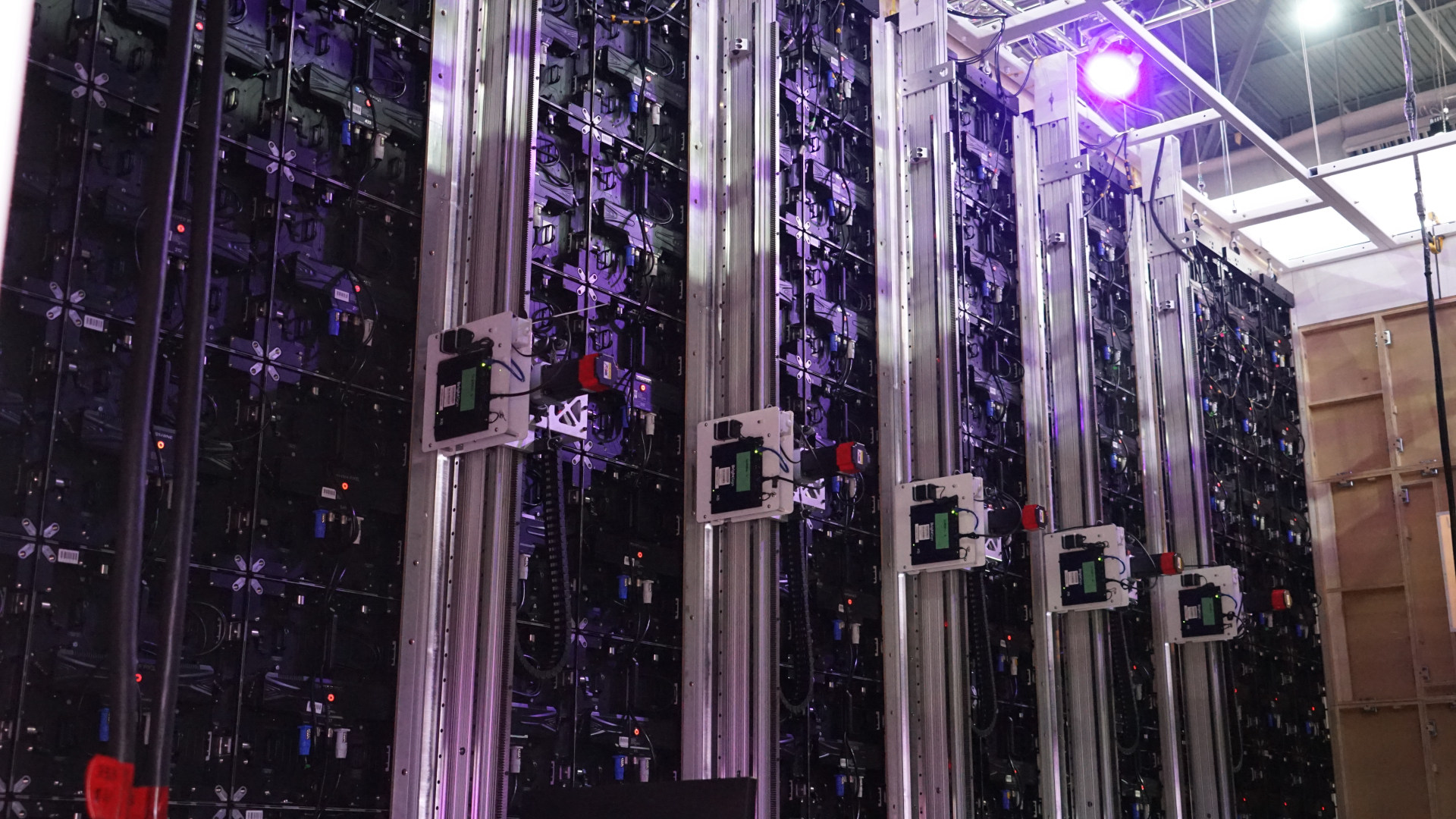 Rear view of a video wall with five motorized vertical monitor columns